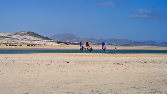Pájara, Fuerteventura, Spain, February 20, 2024 - Surfers at Playa de la Barca and Playa de Sotavento de Jandia, Fuerteventura, Canary Islands, Spain.