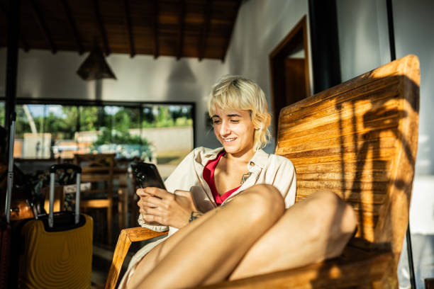 istock Young woman using mobile phone on farm inn 2099822378