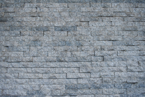 Texture of gray stone brick wall in city