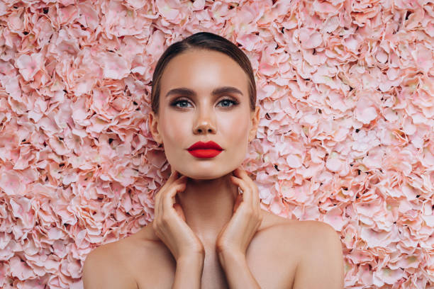istock Beautiful young girl posing on a floral background 2099825565