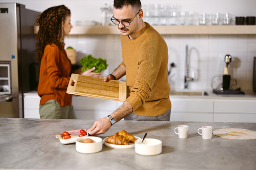 Man and a woman prepare a meal together in the kitchen