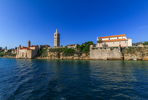 View from the boat over the old town of Rab, historic four church towers, symbol of the city Croatia