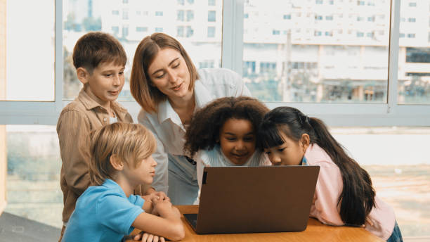 istock Cute girl programing system while surround with teacher and friend. Erudition. 2099848709