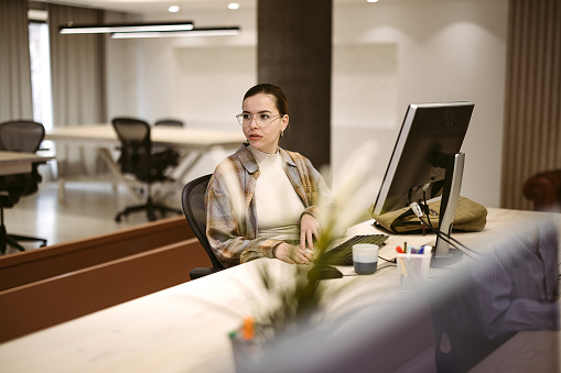 Woman is working in the office on a computer