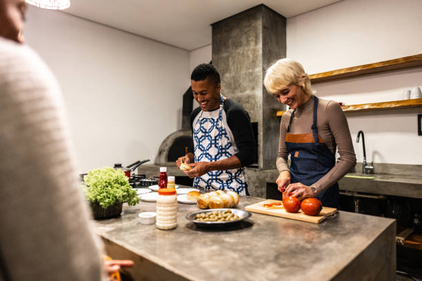 istock Friends cooking and talking on hamburger night at home 2099851933