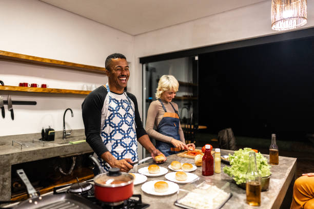 istock Friends cooking and talking on hamburger night at home 2099851937