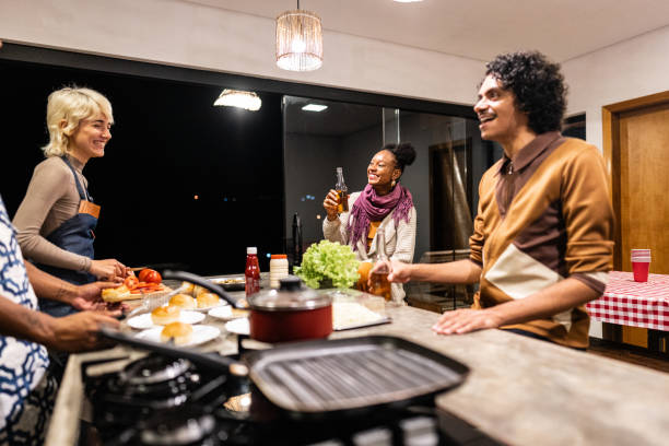 istock Friends cooking and talking on hamburger night at home 2099851955