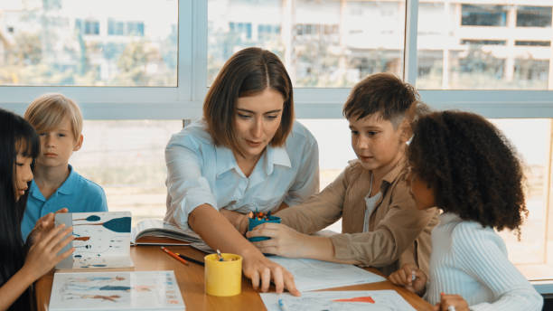 istock Professional caucasian teacher telling story to diverse student. Erudition. 2099858934