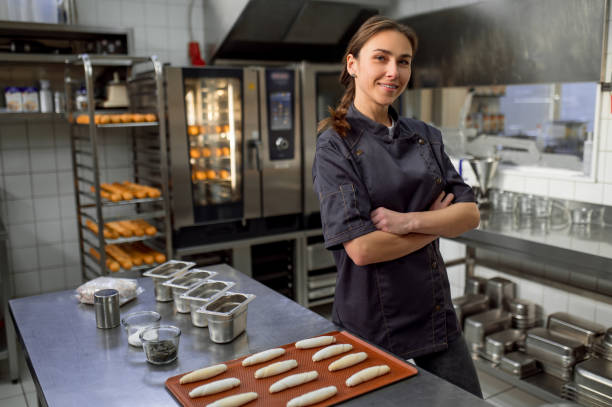istock Woman baker producing classic croissants at bakery 2099861225