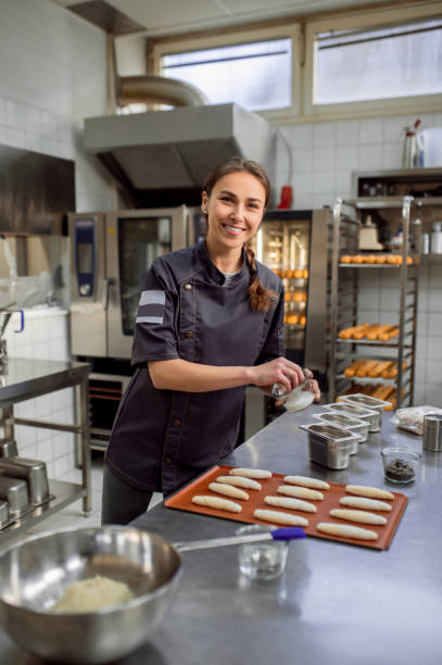 istock Woman baker producing classic croissants at bakery 2099861244