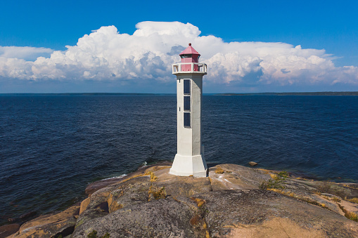 Summer aerial view of Povorotny lighthouse, Vikhrevoi island, Gulf of Finland, Vyborg bay, Leningrad oblast, Russia, sunny day with blue sky, lighthouses of Russia travel