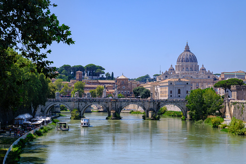 Rome, IT - 11 August 2023: St Peter Basilica and Tiber River