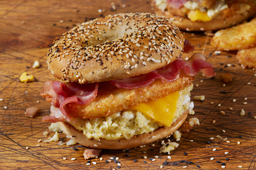 The Everything  Bagel Breakfast Sandwich with Scrambled Eggs, Bacon, Cheddar Cheese and Crispy Hash browns