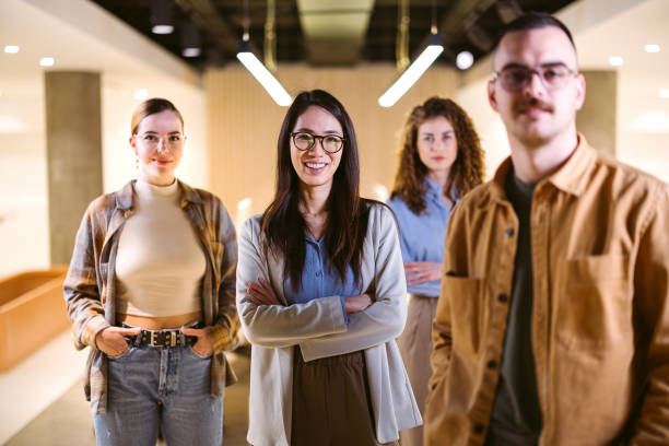 Group of successful business team standing in the office and looking at the camera