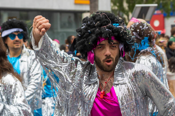 Limassol, Cyprus, March 17th, 2024: Young man in shiny costume dancing at Grand Carnival Parade