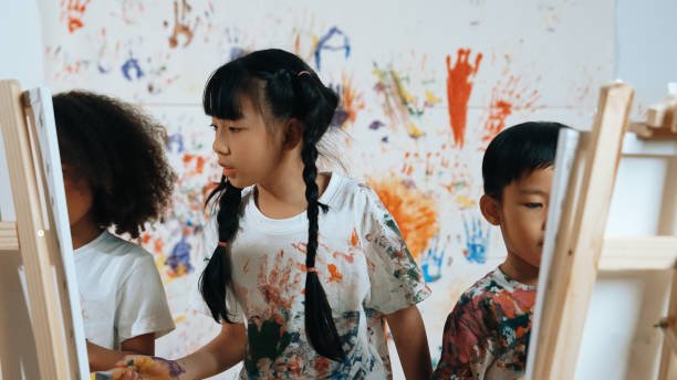 istock Student painted or draw canvas with diverse friends in art lesson. Erudition. 2099919752