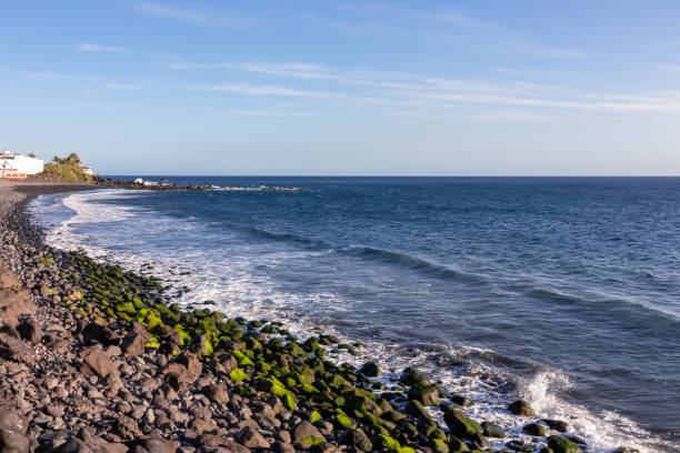 Panoramic view on the beach Playa Valle Gran Rey seen from Promenade de Playa de La Calera in Valle Gran Rey on La Gomera, Canary Islands, Spain, Europe. Pebble beach and dark volcanic sand beach