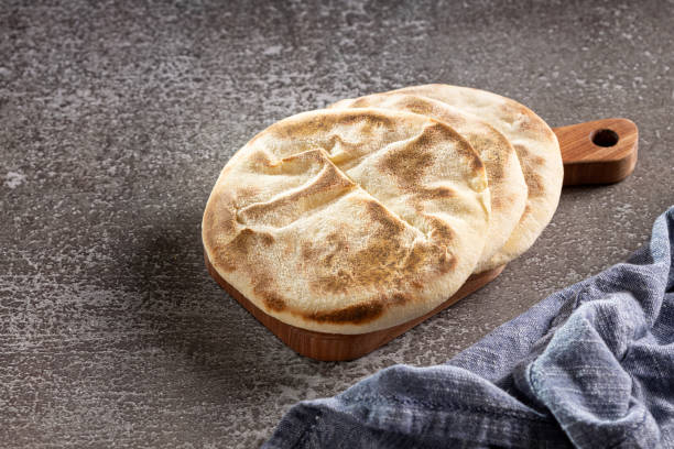 istock Pita bread on the table. Arabic lebnani bread. 2099953544
