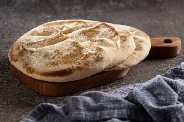istock Pita bread on the table. Arabic lebnani bread. 2099953549