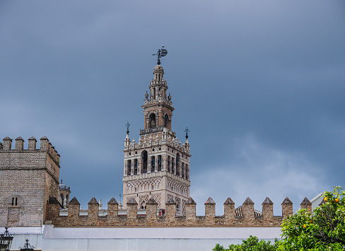 Seville, Spain-March 20, 2024: Giralda tower of the Seville cathedral, on Avenida de la Constitución, city center of Seville.