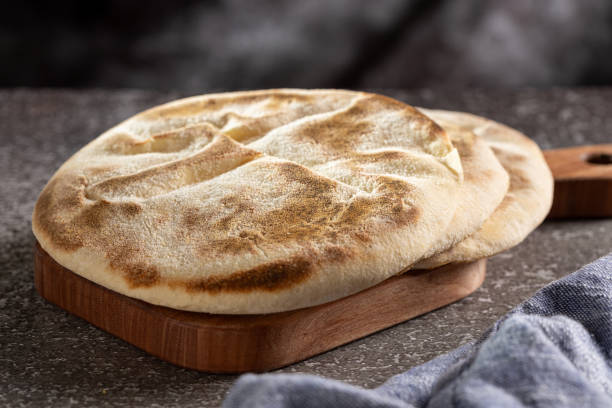 istock Pita bread on the table. Arabic lebnani bread. 2099955706