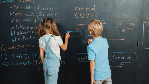 istock Girl and boy writing blackboard with engineering prompt or coding. Erudition. 2099963137