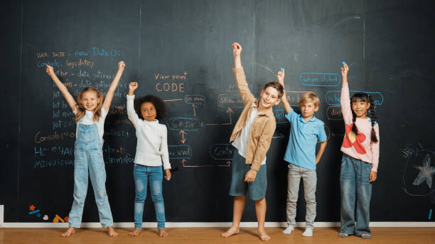 istock Happy diverse student raising hands up while standing at blackboard. Erudition. 2099975215