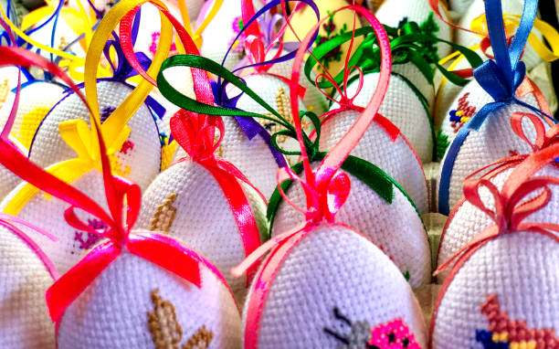 Easter. Close-up of colored eggs embroidered with cross stitch.