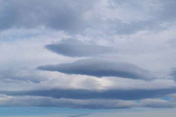 Clouds of unusual shape. Overcast sky. It's a nasty day. Before the rain, before the thunderstorm, before the snow. Bad weather. Sky background. Heavenly landscape.