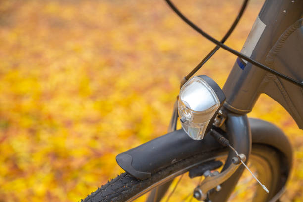 A close-up view captures a row of colorful bicycles parked along a street in Zurich, Switzerland. The image highlights the vibrant colors of the bikes against a blurred background of charming old buildings and leafy trees, creating a serene urban atmosphere. Soft natural light enhances the scene, while selective focus draws attention to the bicycles in the foreground.