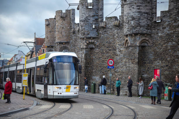 Ghent, Belgium—Nov 22 2023: a tram driving through Gravensteen in winter