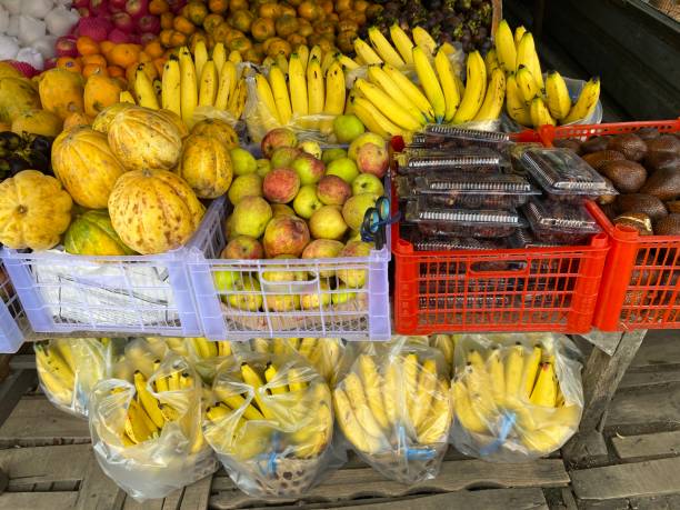 istock Banana, apple, dates, and various colorful fruit sold on market stall 2100103227