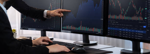 istock Businessman and broker analyzing stock graph at trading company. Trailblazing 2100106433