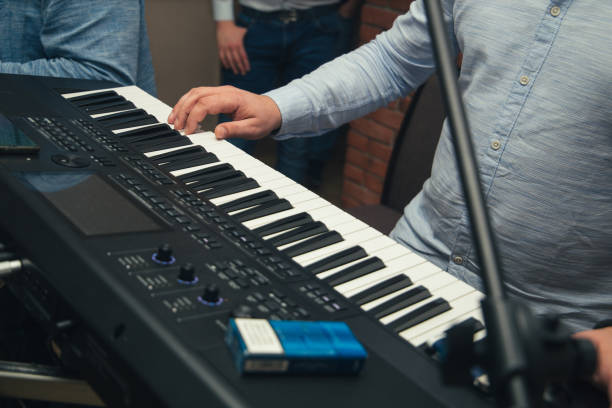 Man playing a synthesizer stock photo