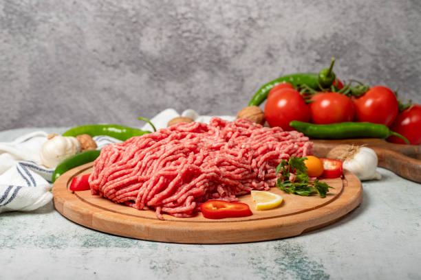 istock Ground beef. Raw ground beef or minced meat on wood serving board 2100126298