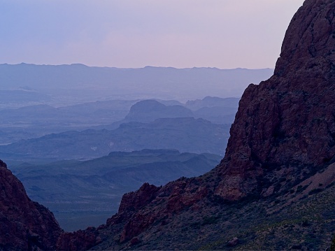 The blue hour opening through the window view of the Chisos mountains in Big Bend national park.