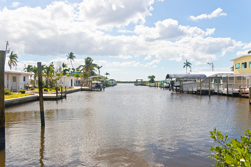 Florida homes with jetties and boats on a canal at the Pine Island Sound, Gulf of Mexico, Florida, USA.