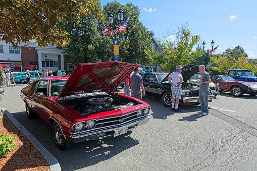 Spectators and owners mingle around 1969 Chevrolet Chevelle SS-396  at the New England Classic Car Show along main street in Andover Massachusetts, July 30, 2023