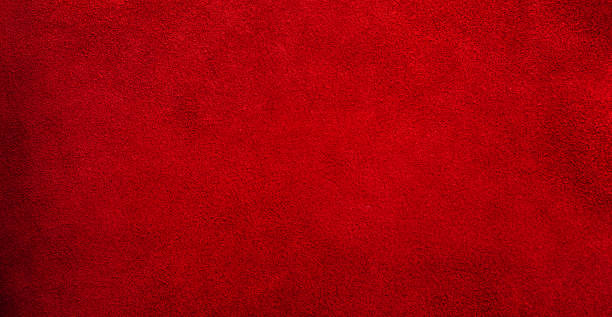 istock Suede genuine leather is red as a background. Red velvet material web size. 2100176978