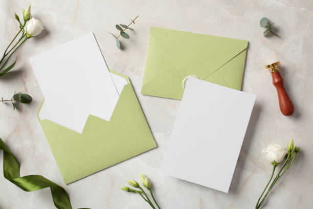 istock Wedding stationery set. Flat lay olive envelopes, blank wedding invitation card, flowers on marble background. 2100238705