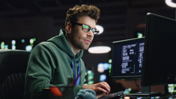 istock Datacenter analyst looking monitors in advanced monitoring office closeup. 2100257901