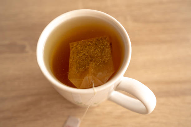 istock A mug of tea with teabag on wooden table 2100306389
