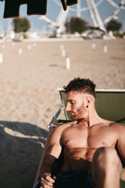 istock Redhead man relaxing on a summer beach. 2100309493