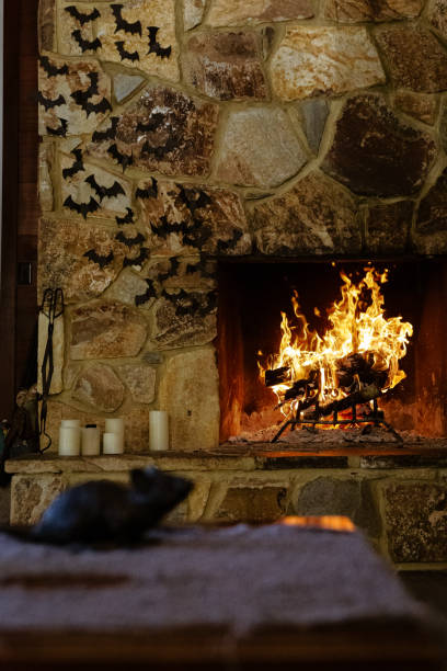 istock Stone wood burning fireplace with black paper bats flying out 2100328201