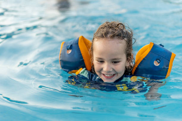 istock A young boy is in the water wearing a life jacket 2100384316