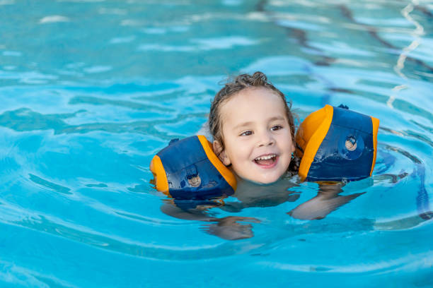 istock A young boy is in the water wearing flotation devices 2100384318