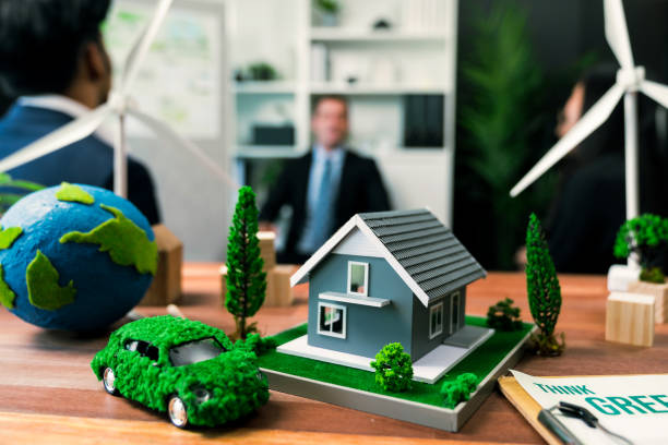 istock EV car model with mockup wind turbine on blurred background meeting. Quaint 2100384323