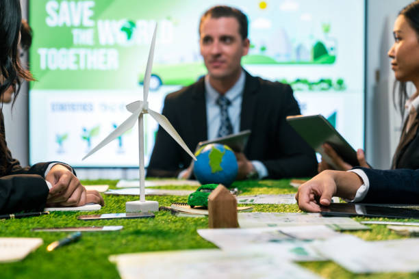 istock EV car model with mockup wind turbine on blurred background meeting. Quaint 2100408823