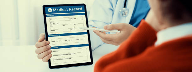 istock Laptop display medical report on blurred doctor office. Rigid 2100490667