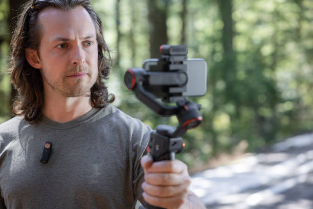 istock Young man filming with a phone gimbal 2100498218